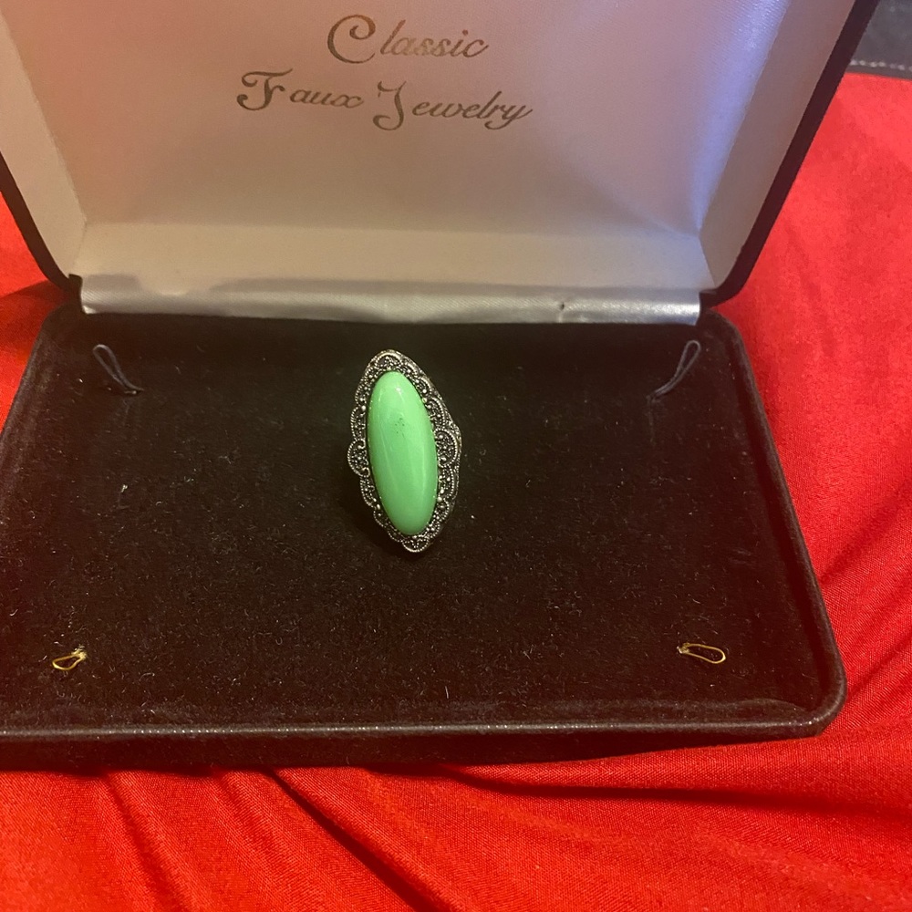 Silver ring, with green stone size 7 trimmed in silver and black.